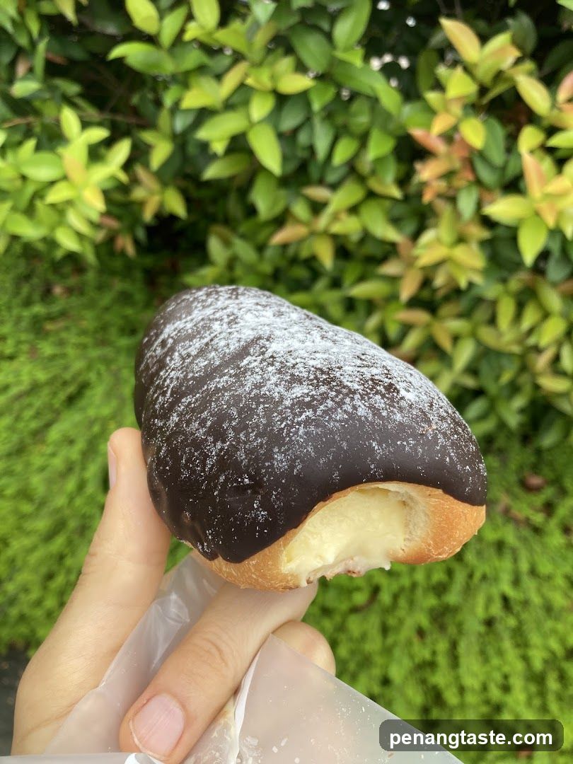 Chocolate-covered pastry with cream filling