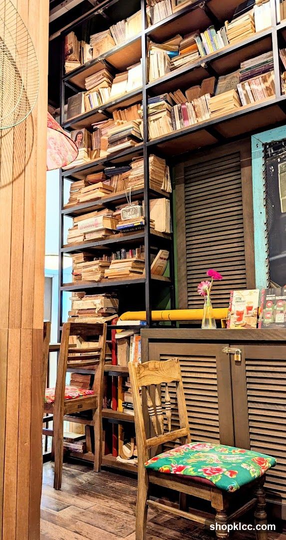 Cozy cafe interior with bookshelves and chairs