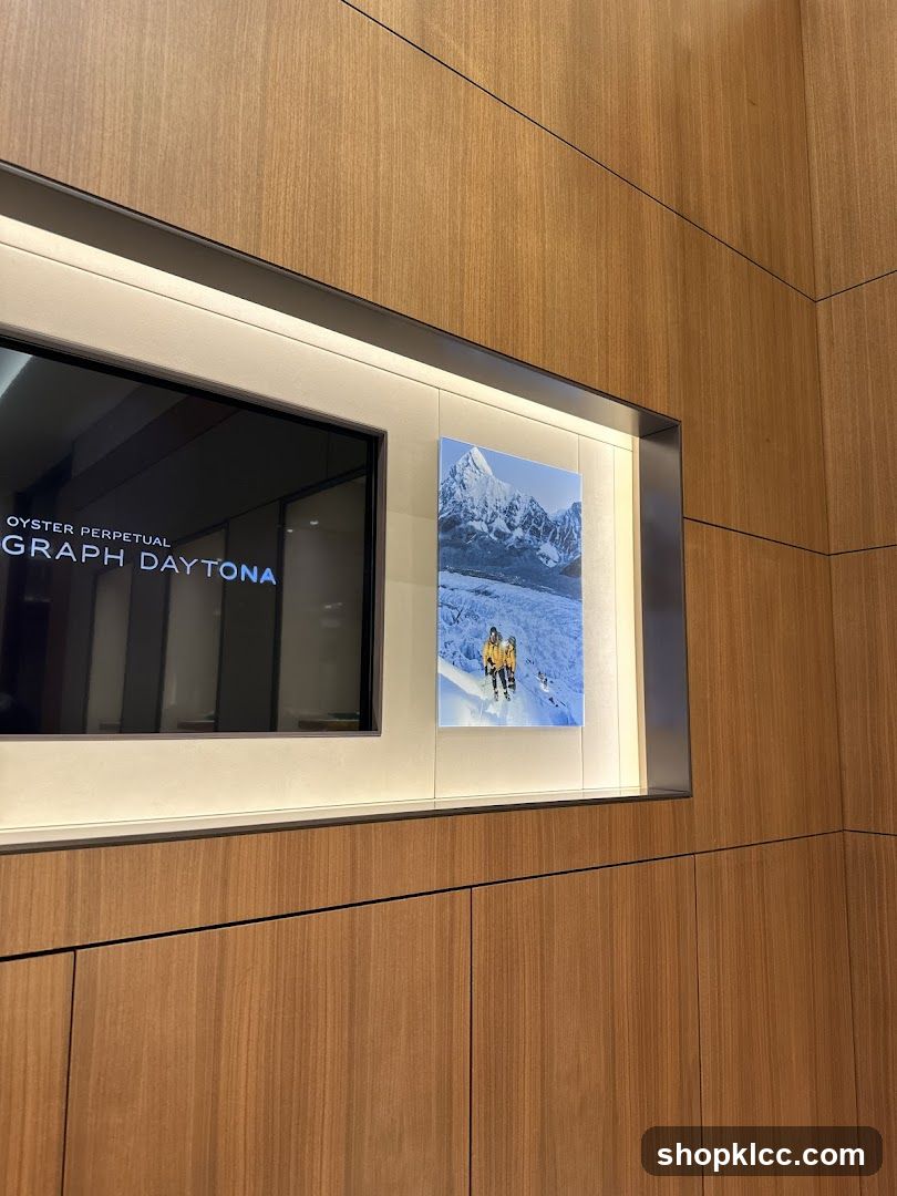 Display with watch advertisement and mountain photograph