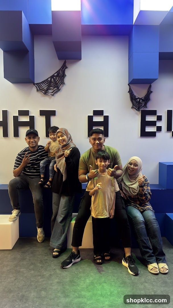 Family Posing in Front of Pixelated Wall Art