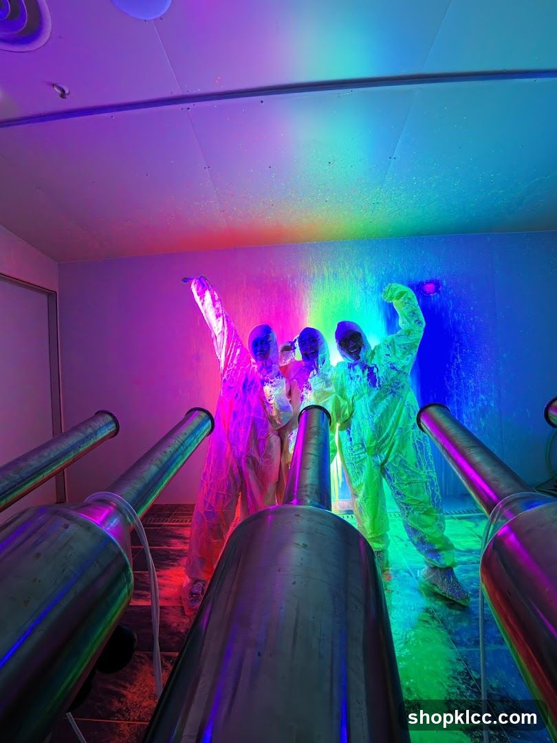 People in protective suits in a neon-lit room