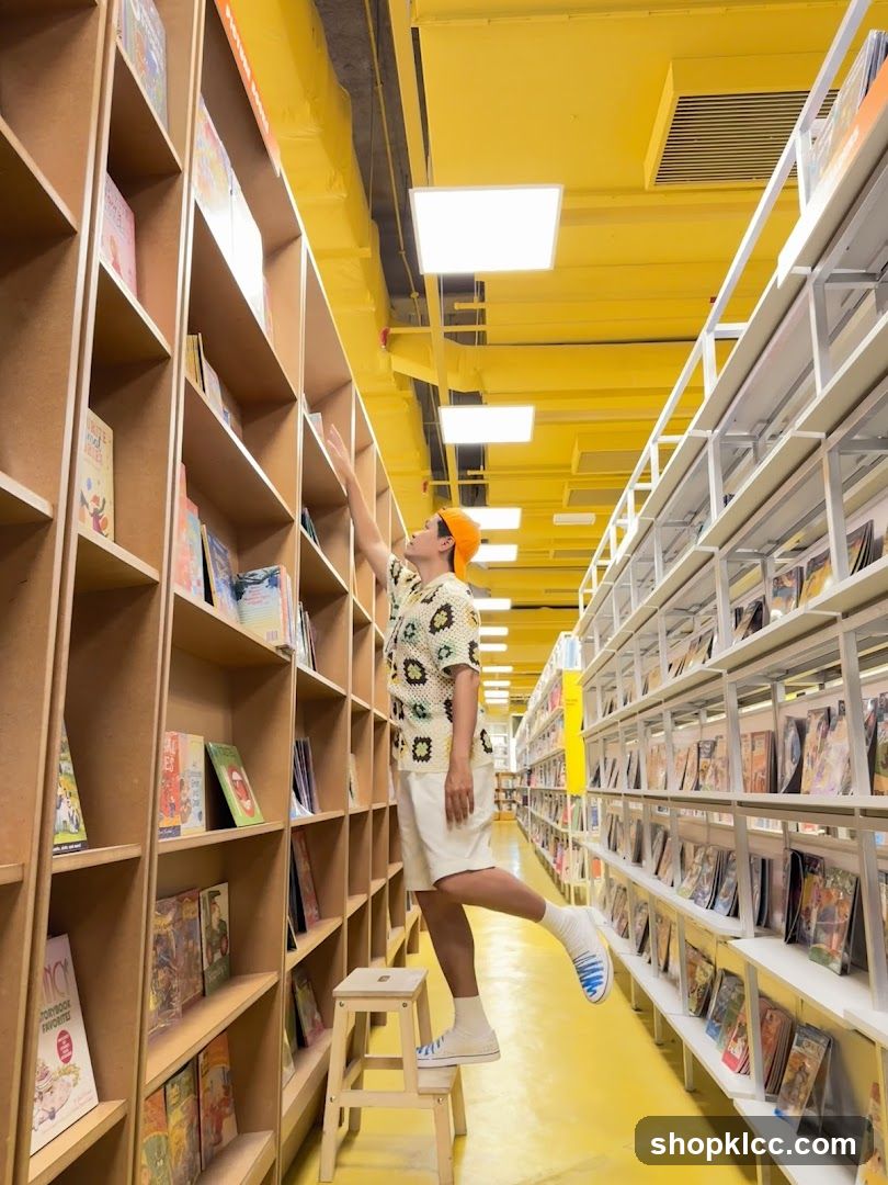 Person reaching for a book in a brightly lit bookstore