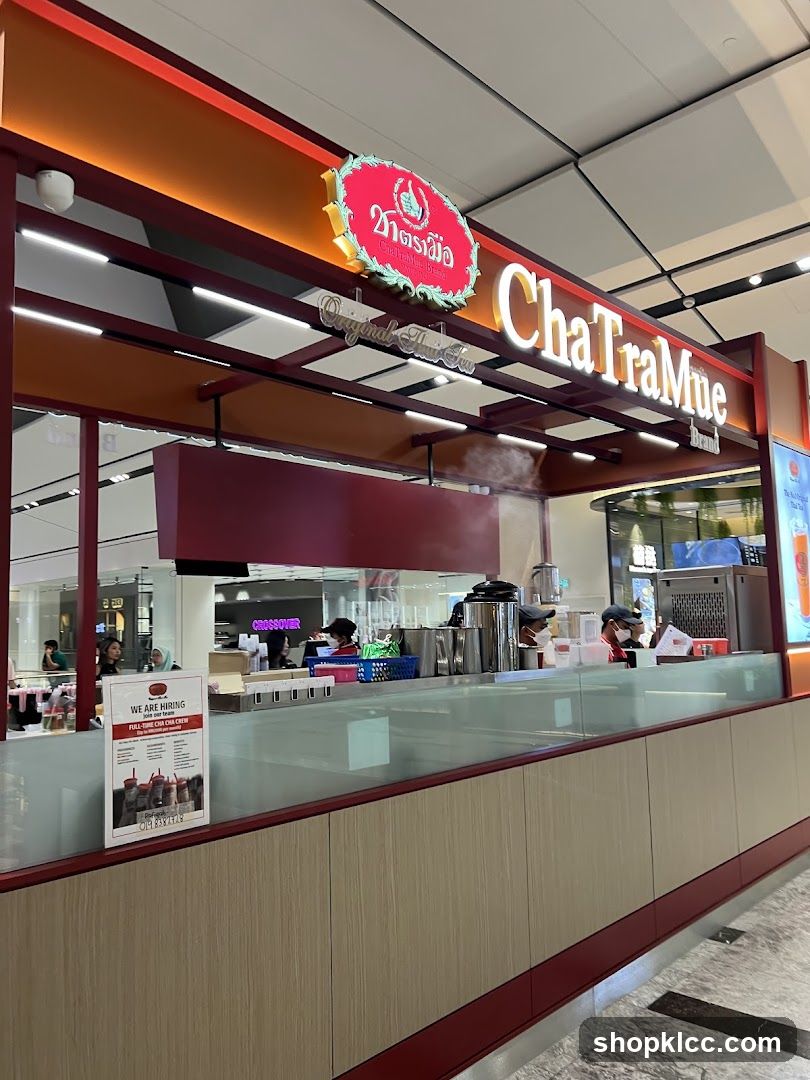 A ChaTraMue brand shop front with its logo and name prominently displayed. The shop appears to be in a mall or airport setting, with customers and staff visible behind the counter. A "We Are Hiring" poster is displayed on the left side of the counter.