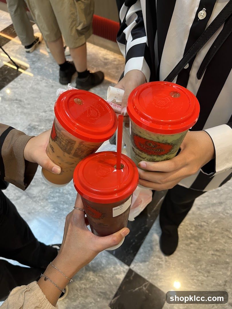 Three drinks being held up