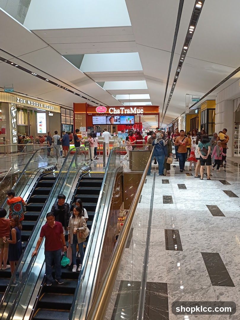 Busy Shopping Mall with Escalators and Food Stalls