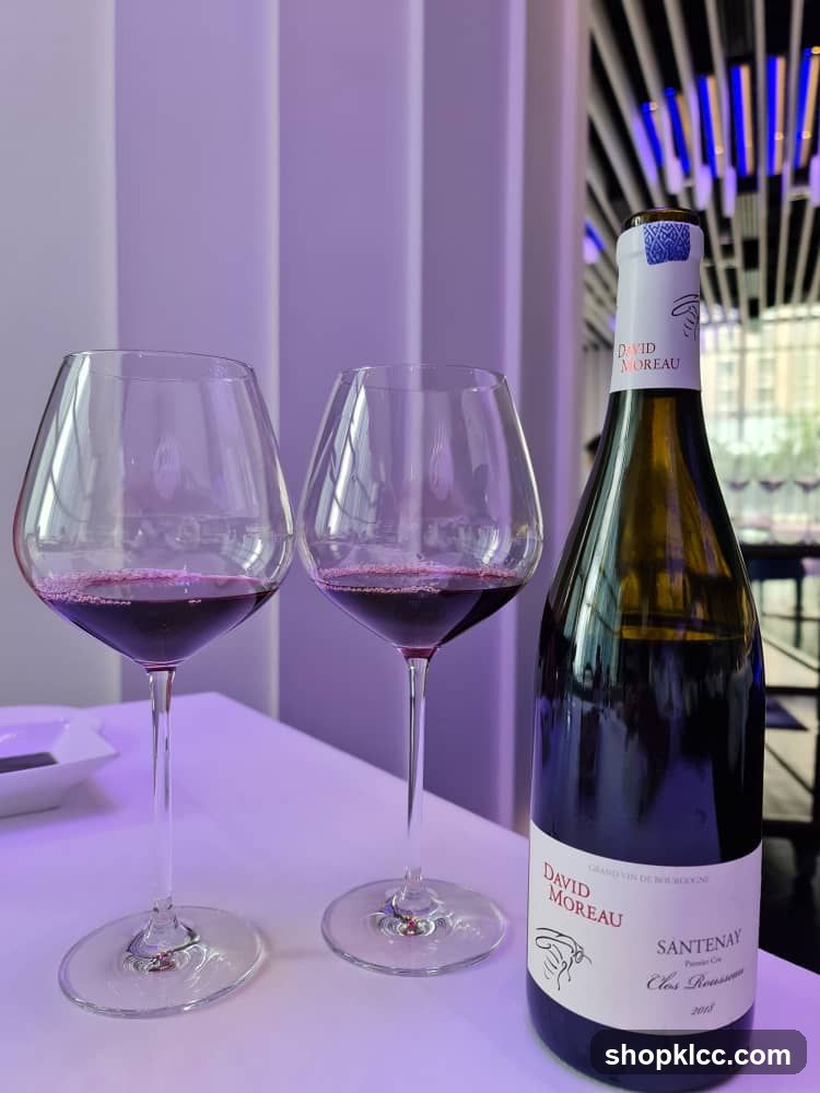 Two glasses of red wine and a bottle of wine
