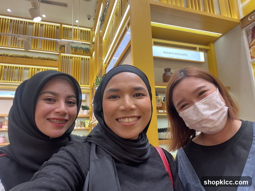 Three women smiling for a selfie in a store