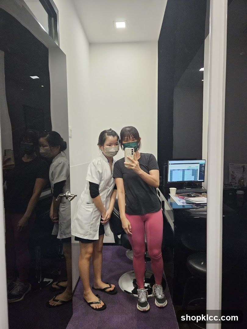 Two women in masks taking a mirror selfie