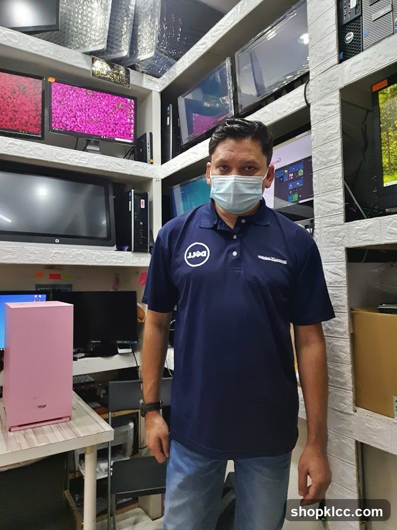 Man in Dell Polo Shirt Surrounded by Electronics