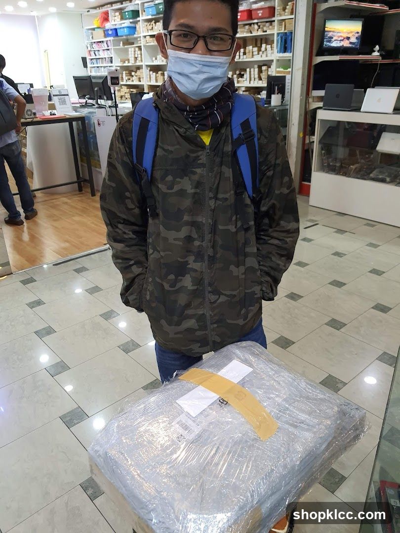 Man with Package in Electronics Store