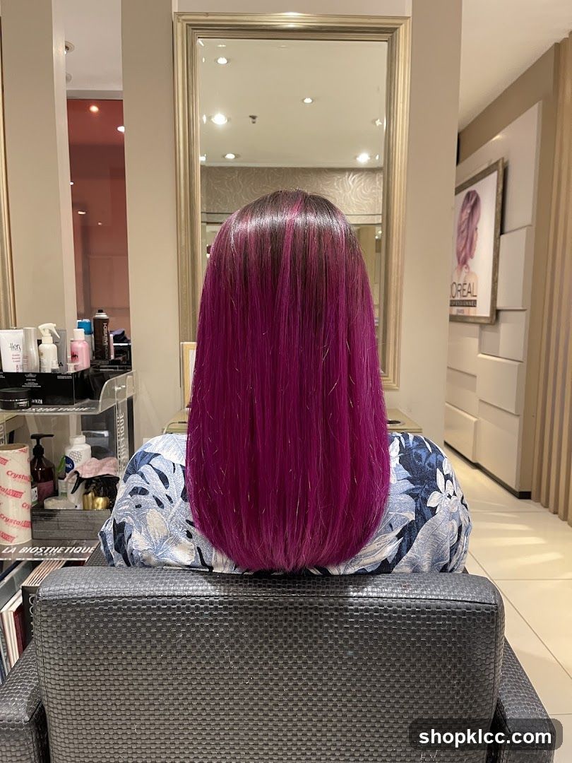 Woman with vibrant purple hair in salon chair