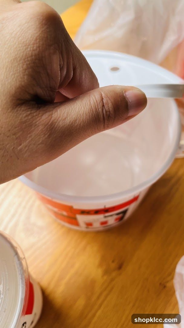 Hand holding a lid over a bowl