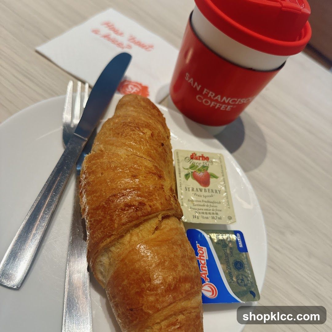 Croissant with coffee and condiments