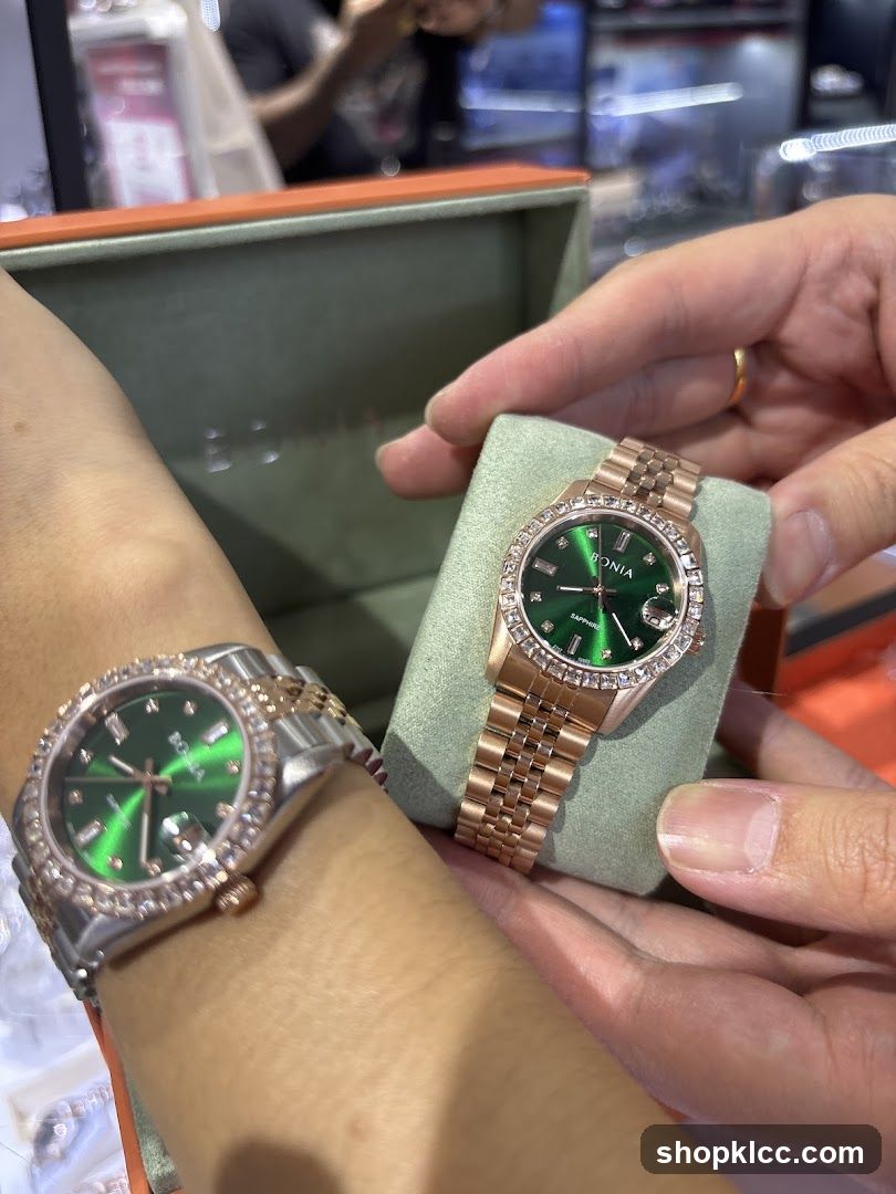 Two watches with green dials and diamond bezels