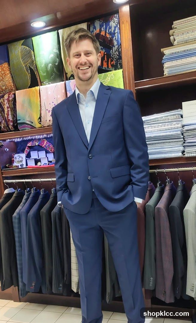 Man in a blue suit in a tailor shop