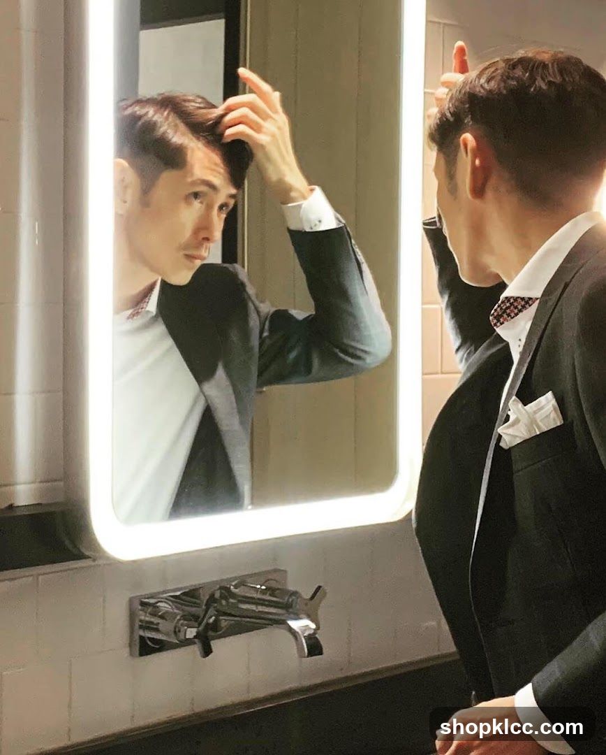 Man adjusting hair in mirror