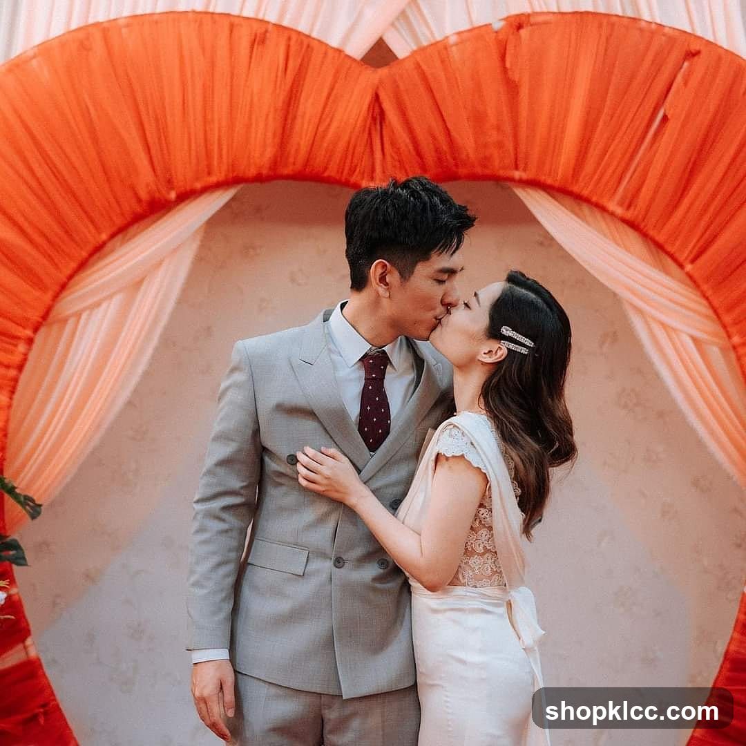 Couple kissing in front of heart-shaped arch