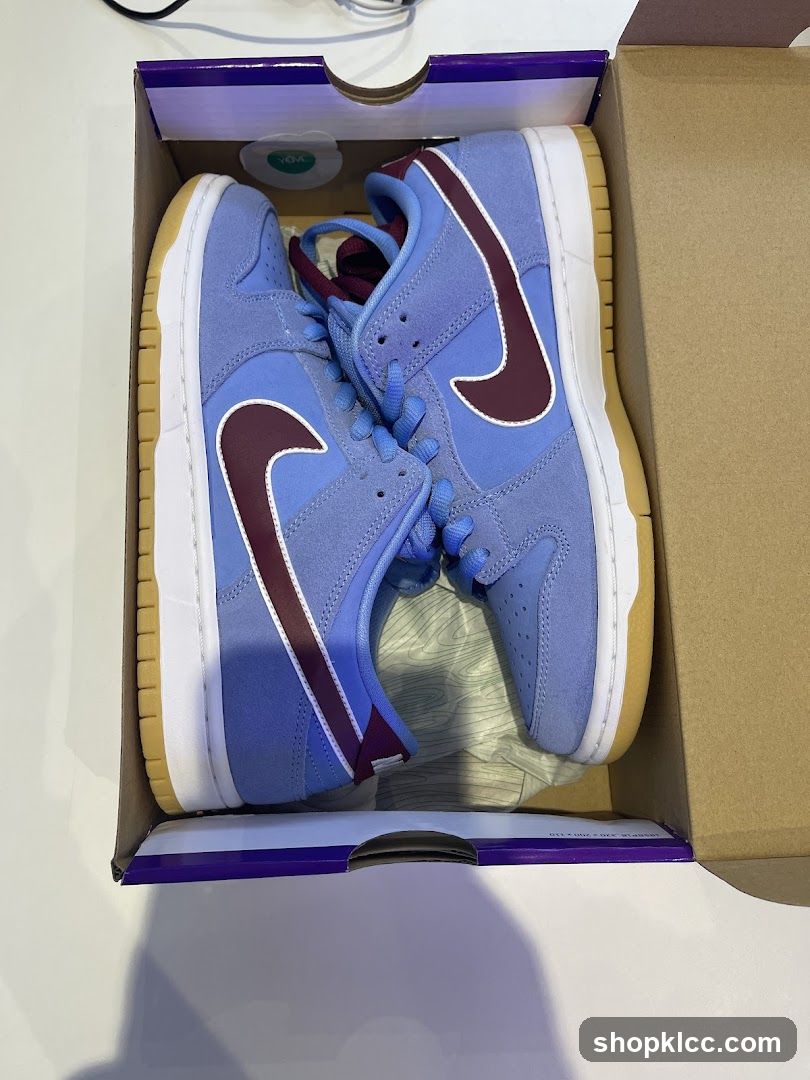 Pair of Blue and Burgundy Nike Dunk Low Sneakers in Box