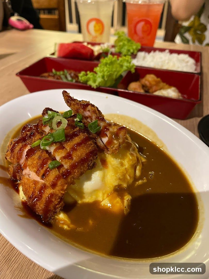Curry dish with fried salmon and rice