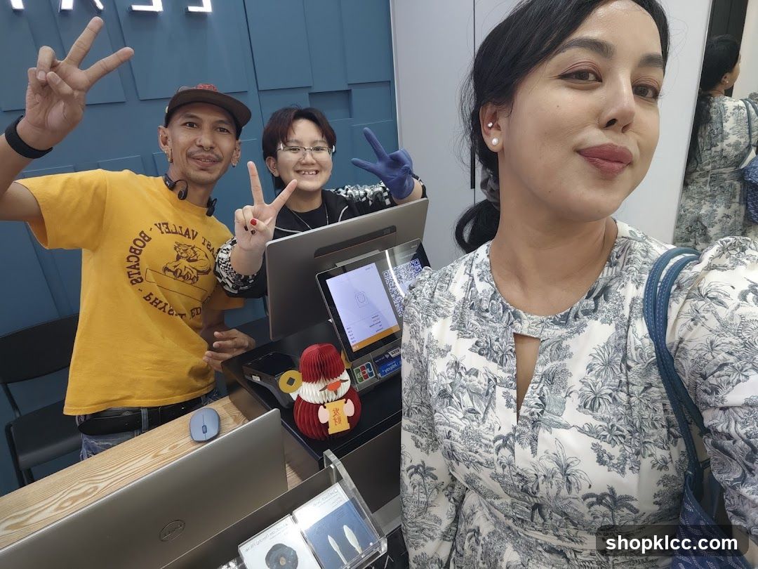 Three people posing for a selfie at a counter