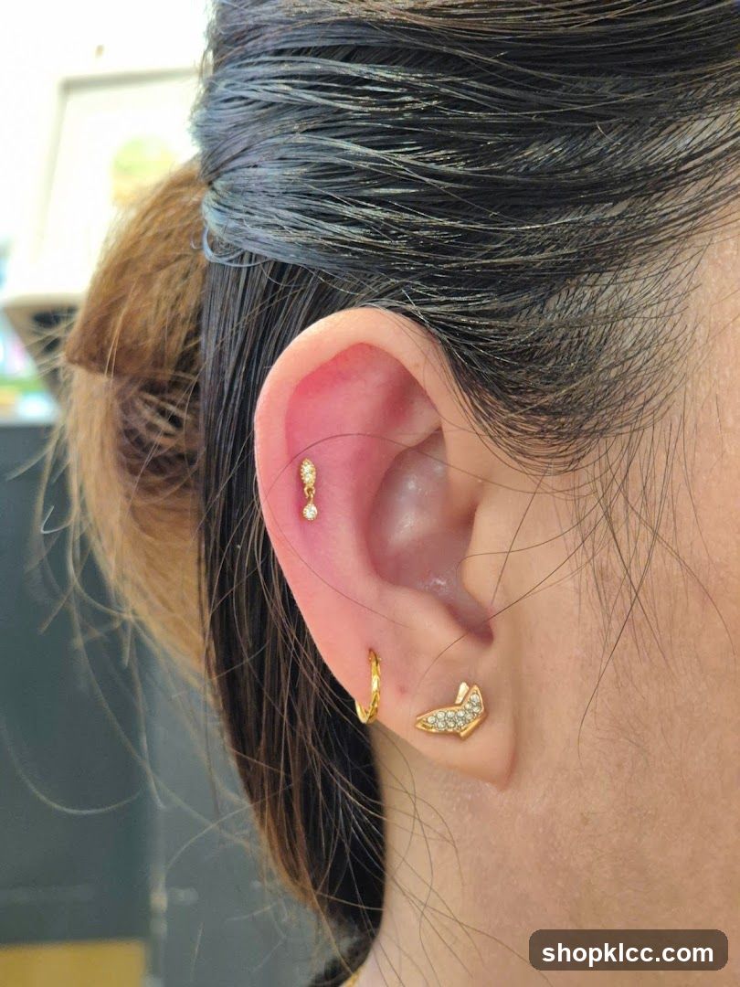 Close-up of a woman's ear with piercings and jewelry