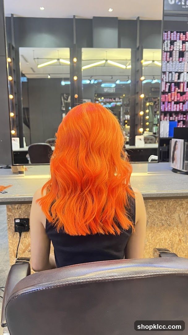 Woman with vibrant orange hair in a salon