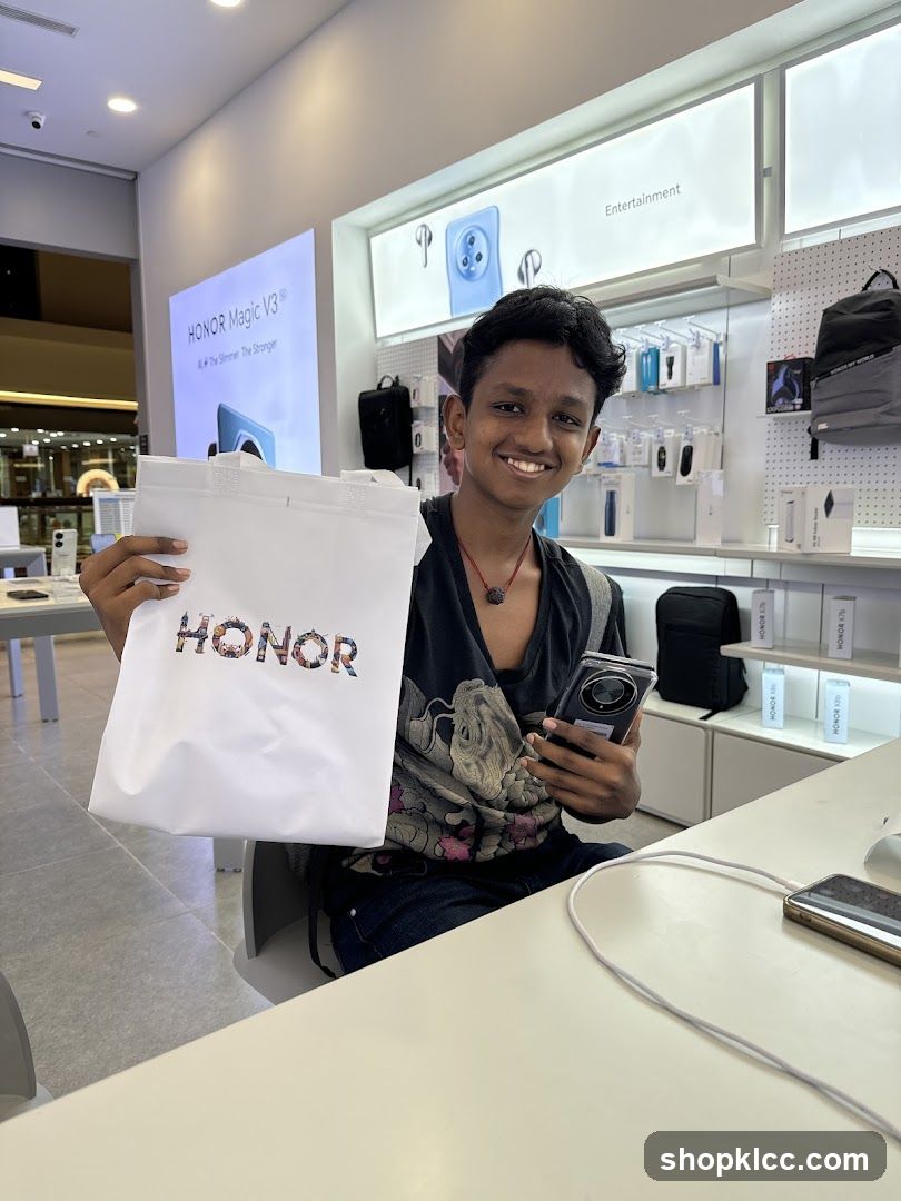 Young man holding a shopping bag and a phone in a store