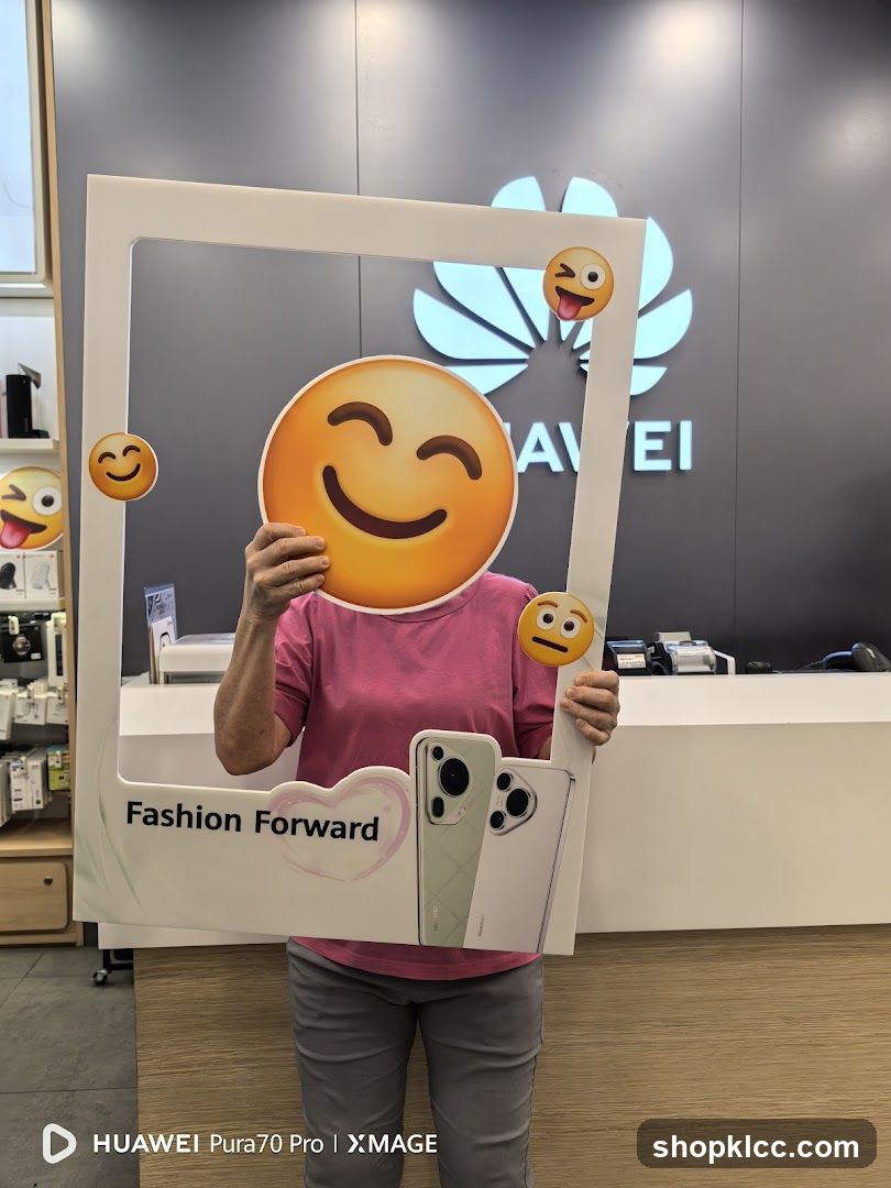Person holding a photo frame with emojis and phones