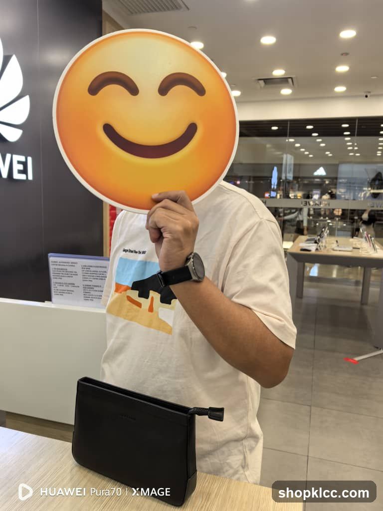 Person holding a smiley face emoji cutout in front of their face