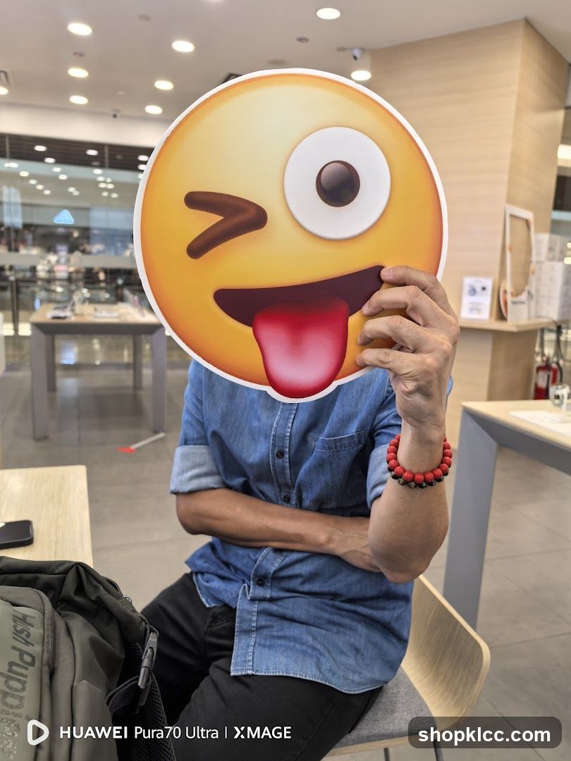 Person holding an emoji cutout