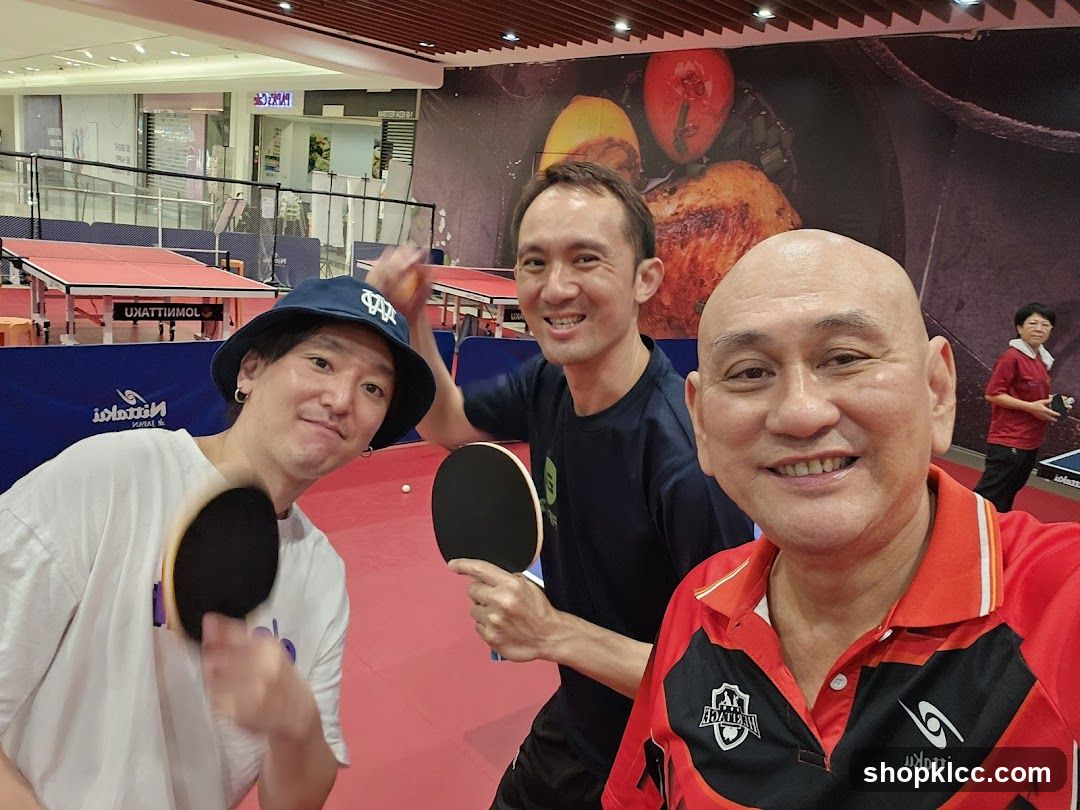Three men playing table tennis