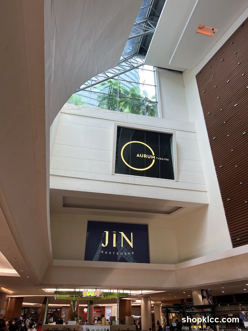 Indoor mall with signage for "Aurum Theatre" and "Jin Gastrobar"