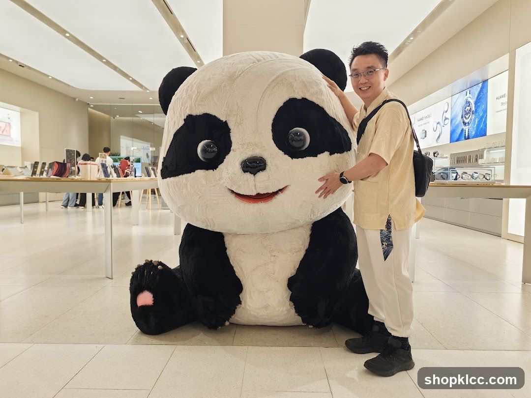 Man Posing With Giant Panda Plush Toy