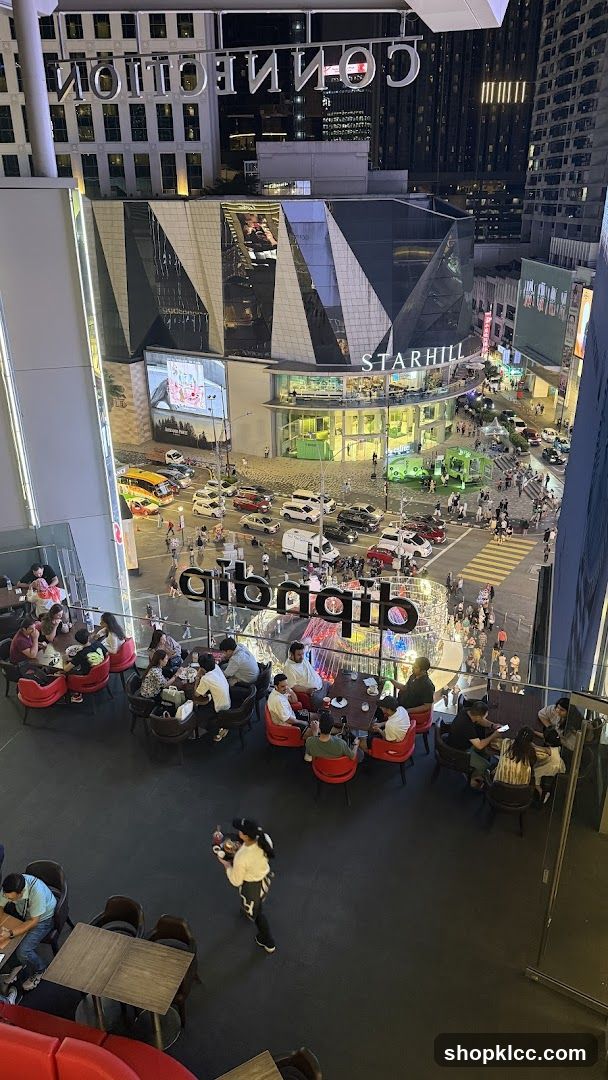 Outdoor seating area with people dining and a busy street scene