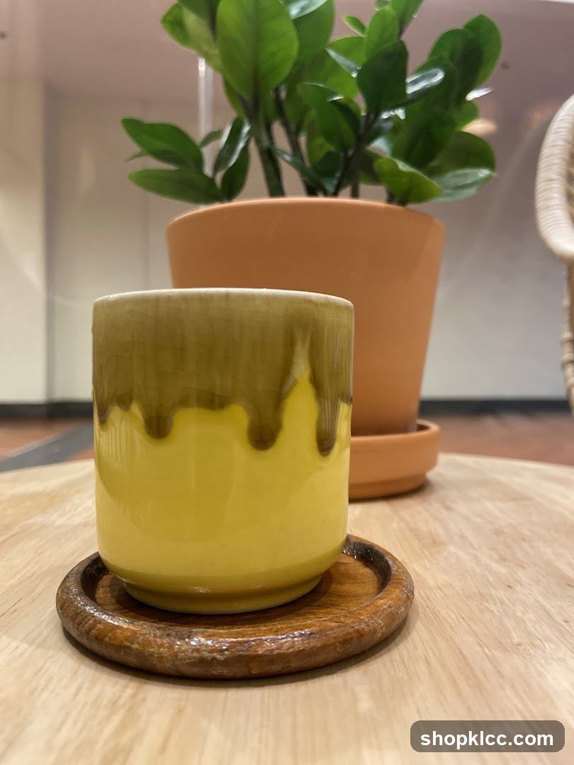 Yellow cup on wooden coaster