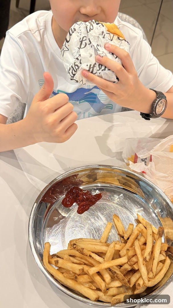 Boy eating a burger and fries