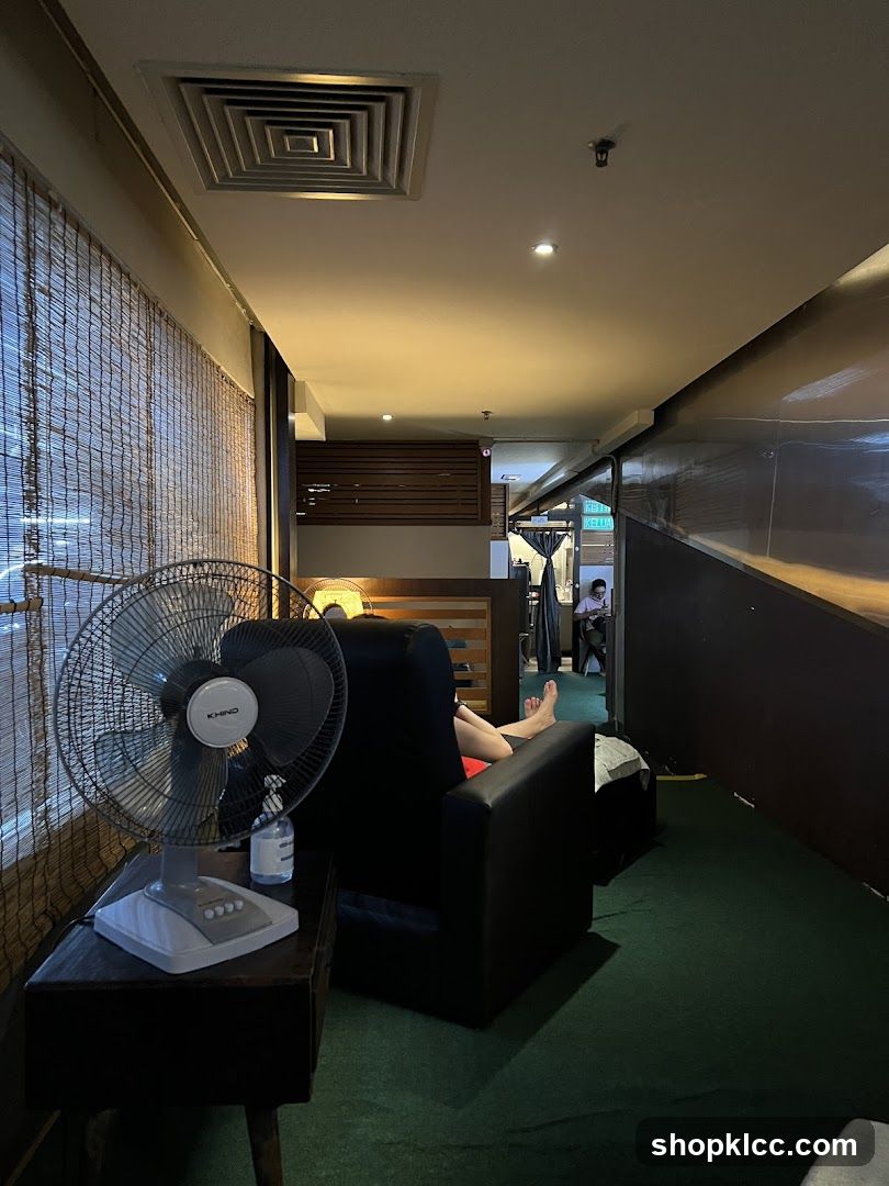 Massage chairs and fan in a dimly lit room