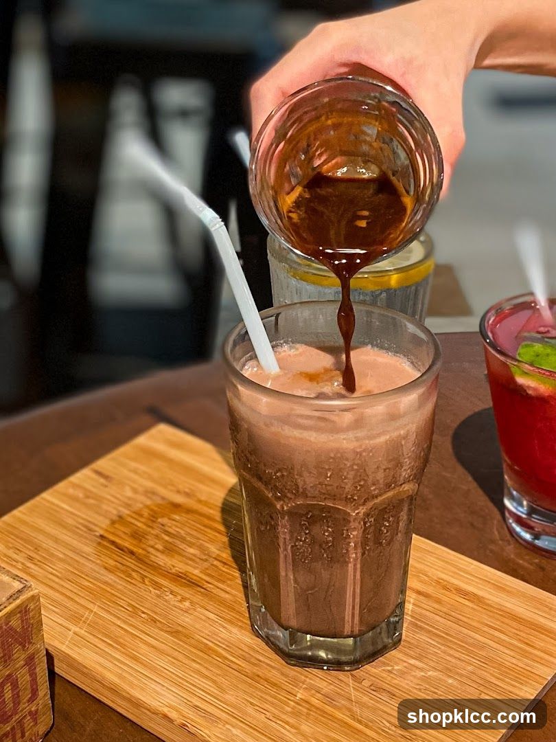 Pouring Espresso into Chocolate Drink