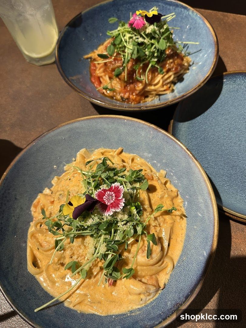 Two bowls of pasta with garnishes