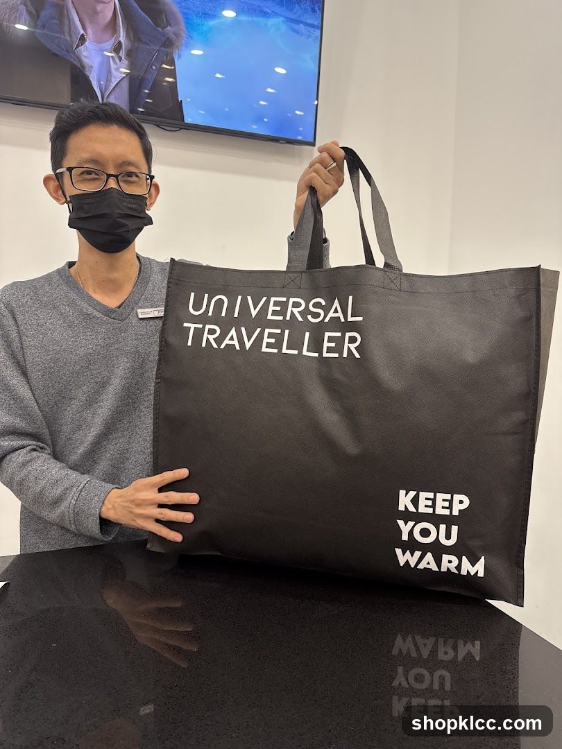 Man holding a branded tote bag