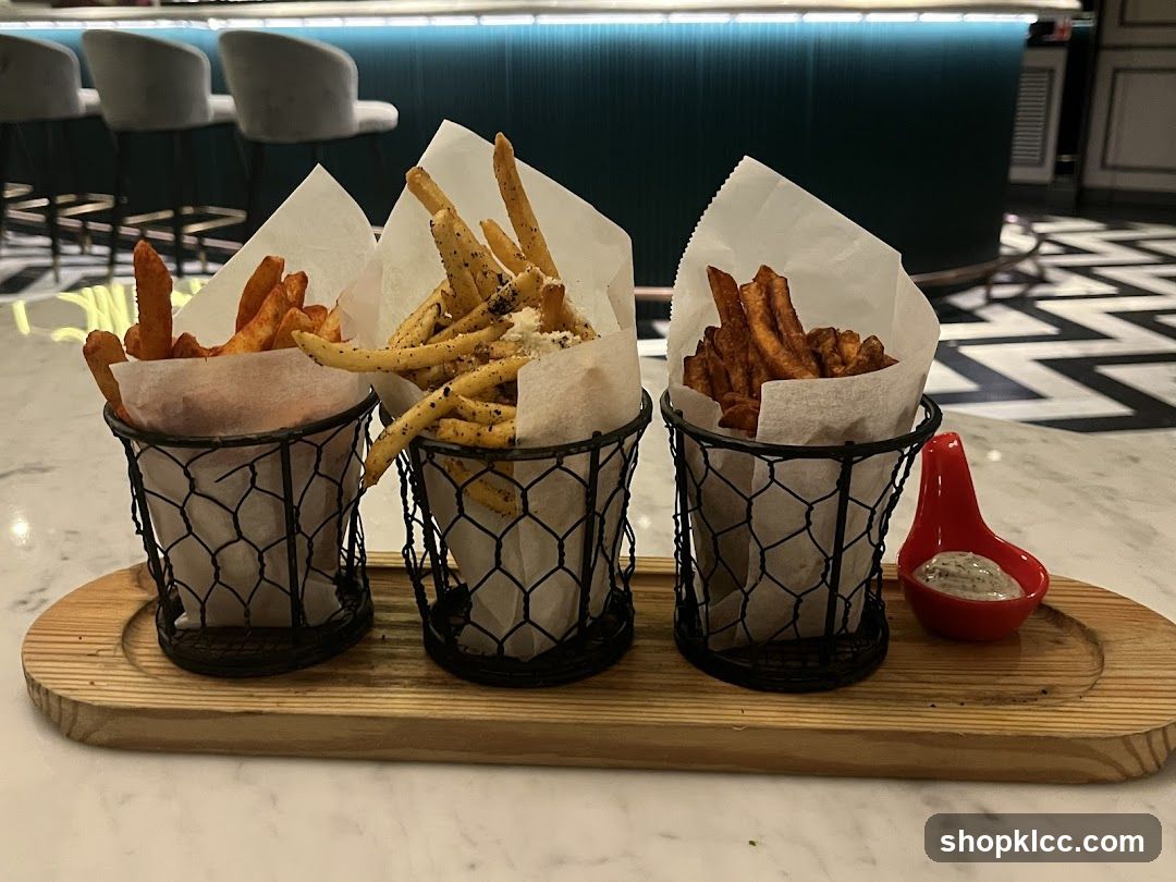 Three types of fries served with dipping sauce