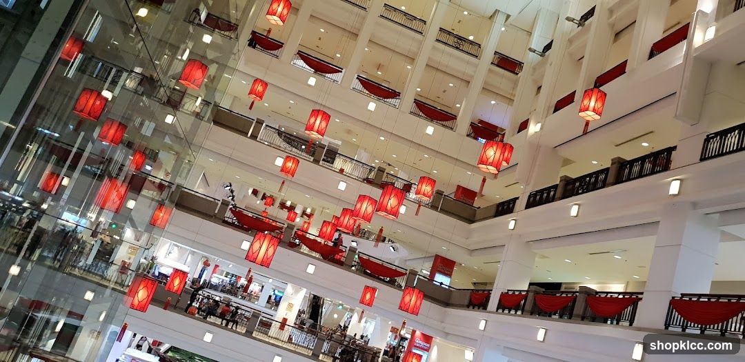 Interior of a multi-level shopping mall decorated with red lanterns.