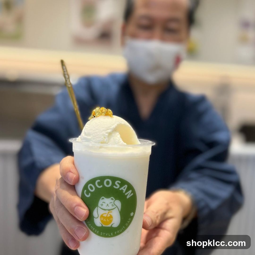 Man holding a drink with ice cream