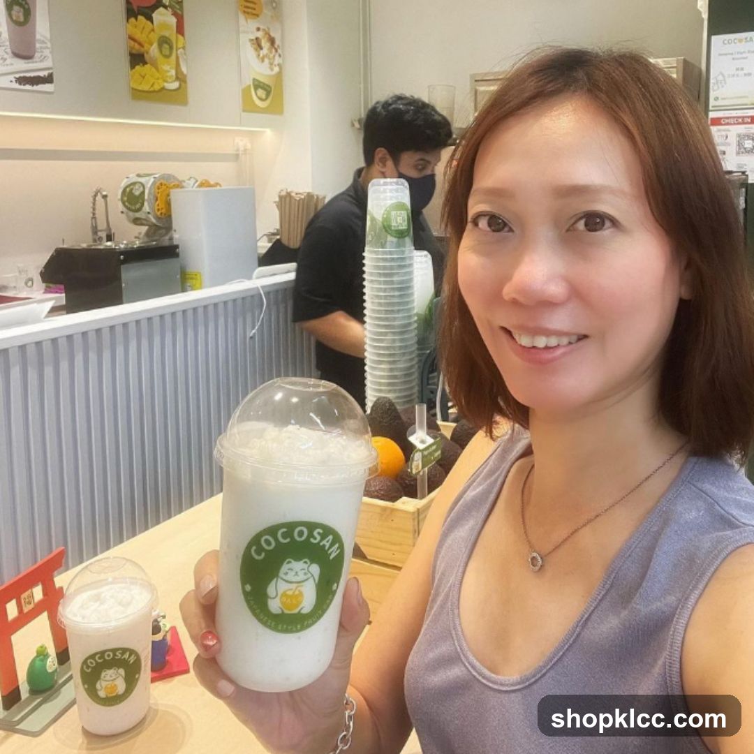 Woman holding a drink at a juice bar