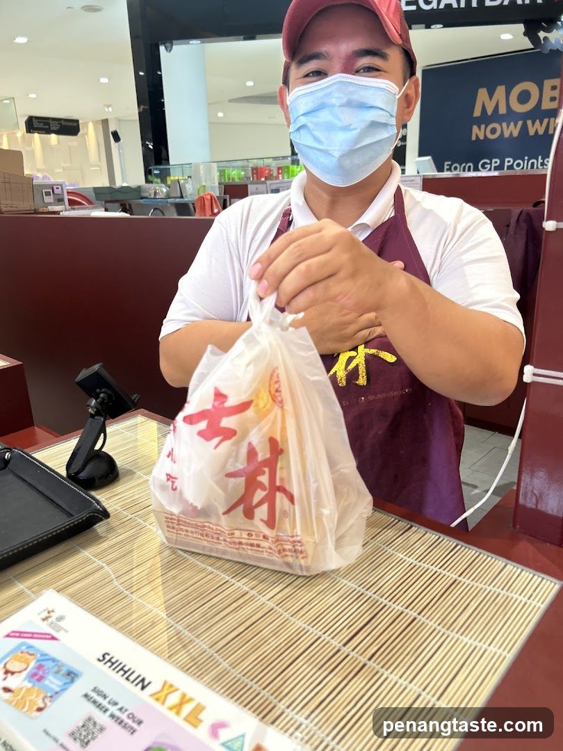 Staff holding a takeout bag