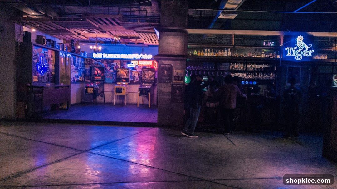 Bar with Arcade Games and Neon Signs