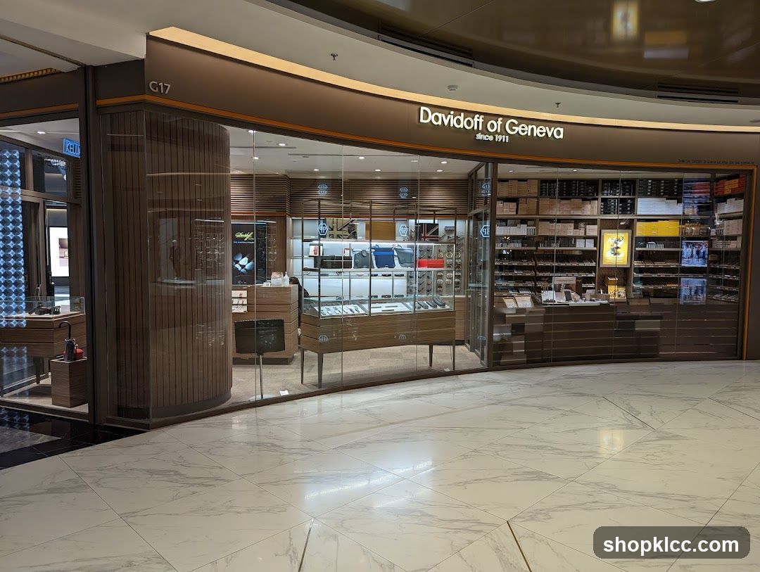 The exterior of a Davidoff of Geneva store, featuring a large glass storefront displaying various products. The store's name and logo are prominently displayed above the entrance. Inside, shelves are stocked with boxes of cigars and other merchandise.