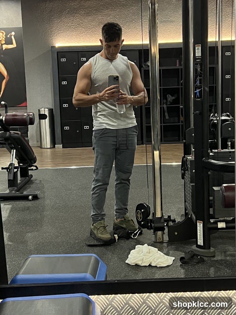Man taking a mirror selfie in a gym