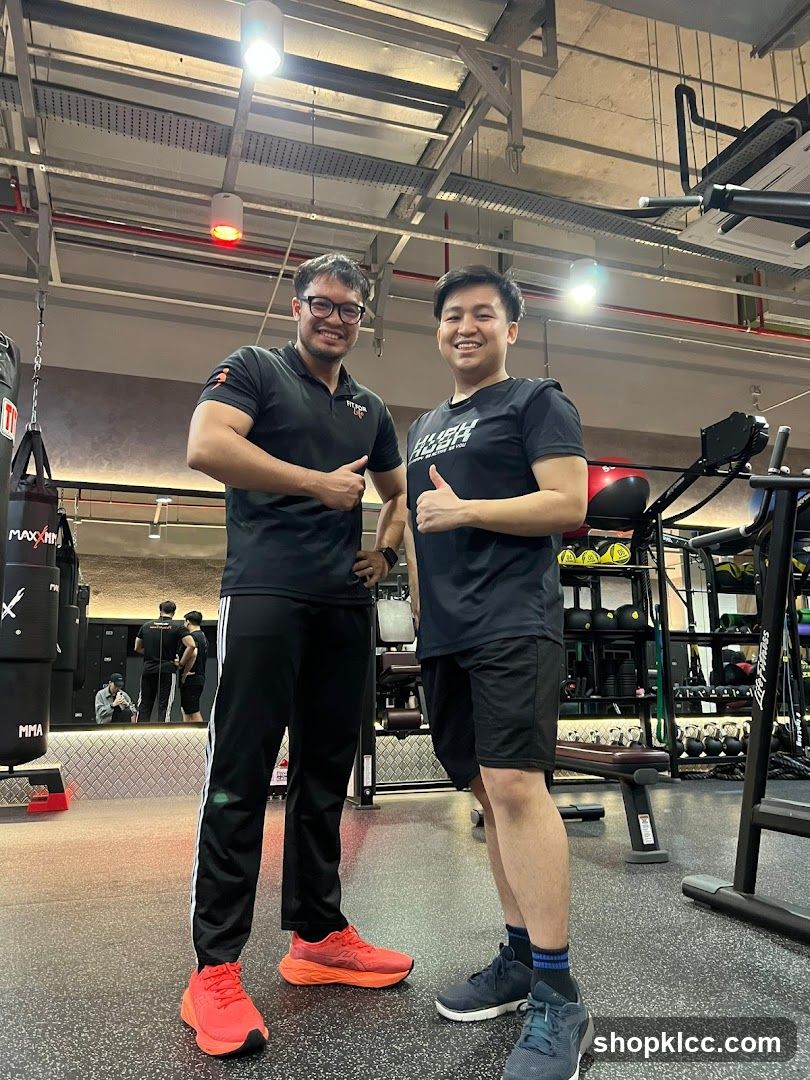 Two men posing in a gym