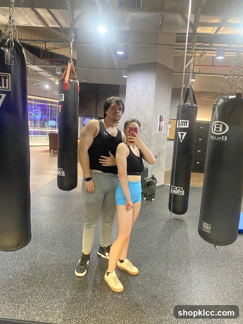 Couple taking a mirror selfie in a gym